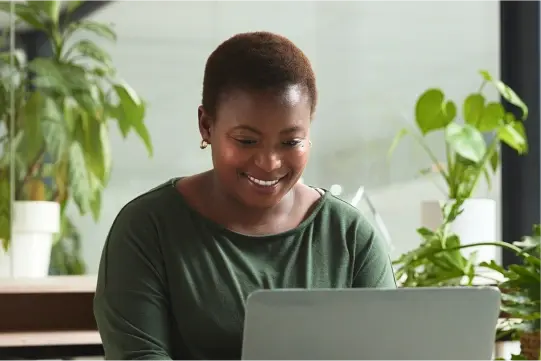 An image of a woman looking at a laptop