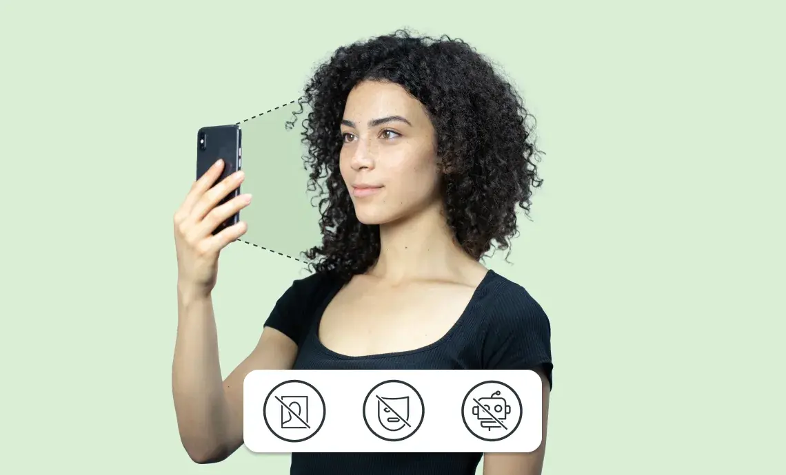 A woman holding her mobile devise to her face to scan her biometrics.
