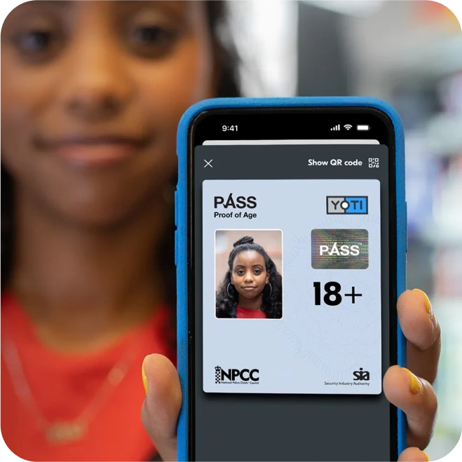 Young woman showing her Yoti Pass Proof of Age card