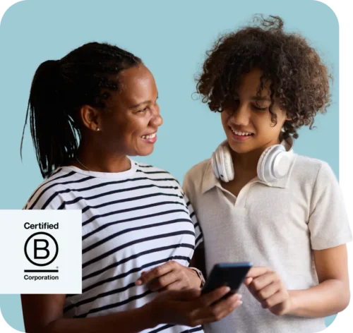 Two young people using a mobile phone. BCorps Certified logo.