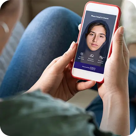 Woman scanning face with smartphone front camera to prove her age